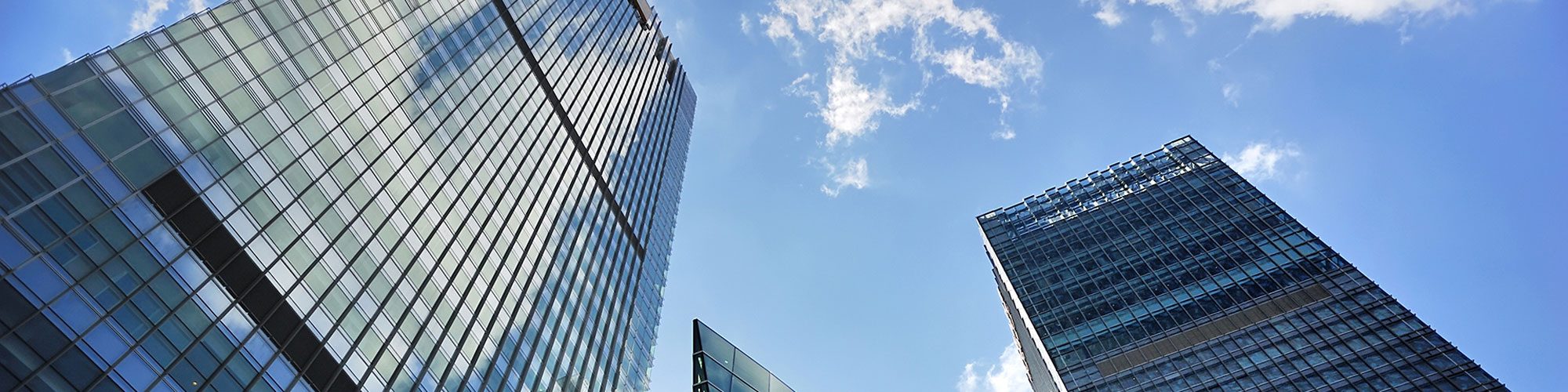 Office building in front of a blue sky.