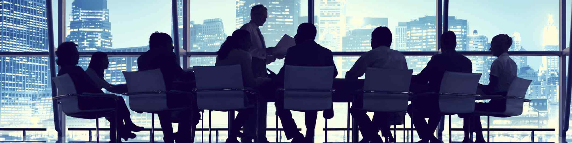 Businesspeople at a conference table in an office building.