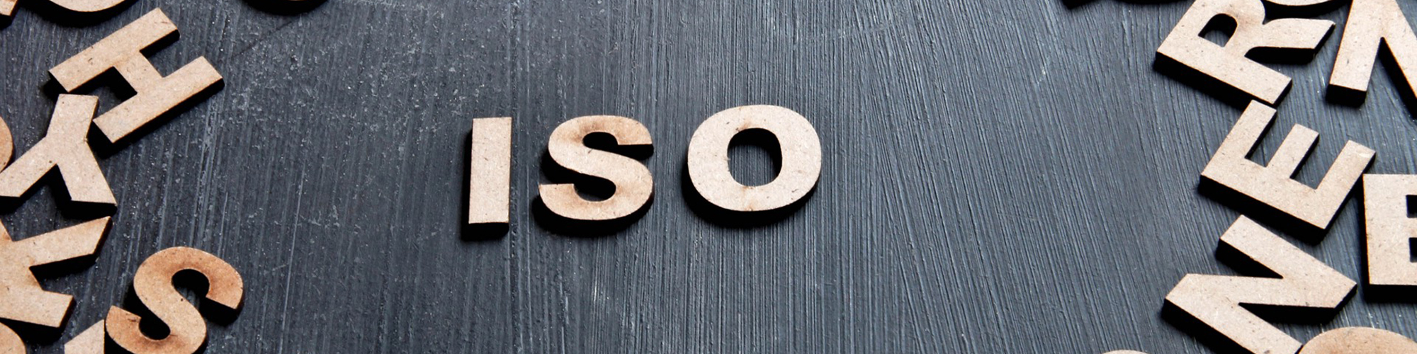 ISO alphabet blocks on a black table.